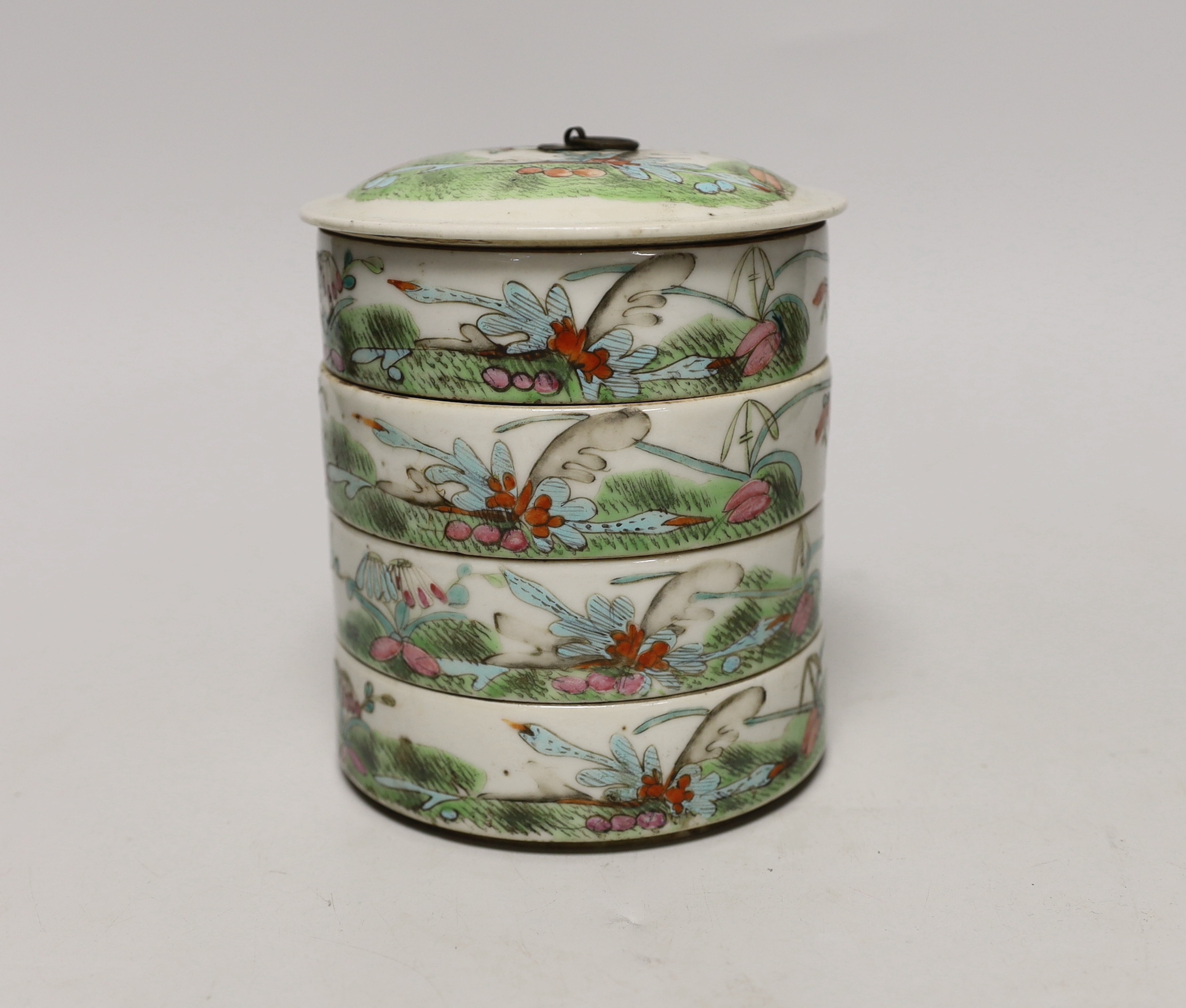 An early 20th century Chinese enamelled porcelain four section stacking food container and cover, 14cm high